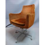 An Industrial desk chair, with brown velour upholstery