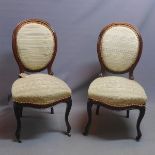 A pair of Victorian rosewood chairs, recently upholstered, raised on cabriole legs and castors