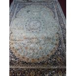 A Kashan style carpet, with central floral medallion, on a green ground, contained by floral