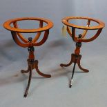 A pair of walnut and part ebonized globe stands, raised on tripod bases