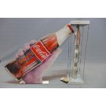 A vintage Coca-Cola sign together with a Coca-Cola sculpture