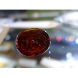 A triple sided intaglio carnelian (possibly a pendant), finely carved with a horse rider, a dog