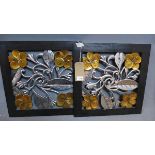 A pair of pierced wooden wall plaques, decorated with flowers, 50 x 50cm