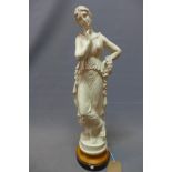A cast plaster figurine of a Classical lady holding a wreath of flowers, on socle base, H.66cm