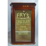 A late 19th century mahogany corner cabinet, with glazed door having advertisement for Fry's