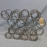 A wrought iron 16 bottle wine rack