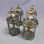 A set of four gilt metal storm lanterns