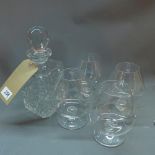 A 20th century cut lead glass decanter together with four brandy glasses