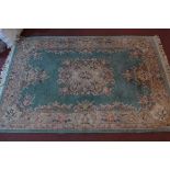 A mid 20th century Chinese woollen carpet, central floral medallion on a turquoise ground within