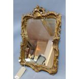 A 20th century gilt mirror decorated in the Rococo taste, with 19th century glass plate, 56 x 37cm