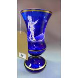A Mary Gregory style cobalt blue glass vase of urn form, decorated in white enamel with a boy in a