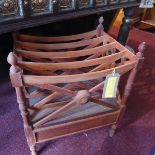 A Regency style teak Canterbury, having four divisions and single drawer, raised on turned legs