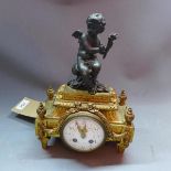 A late 19th century French ormolu and cast metal mounted mantle clock, drum movement, the white