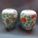 A pair of Chinese famille verte vases, decorated with phoenixes amongst flowers and foliage, bear