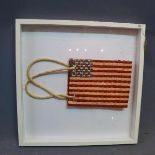 Contemporary study of an American flag in the form of a bag, woven with reeds, within floating