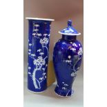 A Chinese blue and white porcelain baluster vase and cover, decorated with prunus, having Dog of