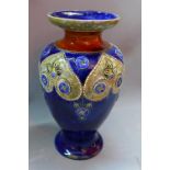 An early 20th century Royal Doulton stoneware baluster vase, with blue glaze and floral