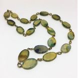 A yellow metal and agate ladies necklace