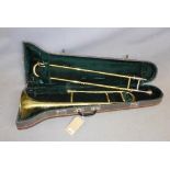 A brass trombone, with travel case