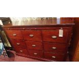 A 20th century mahogany campaign style chest, with two long brush slides, over nine drawers,