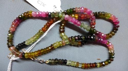 A white metal and tourmaline necklace, having multi-coloured tourmaline beads and white metal