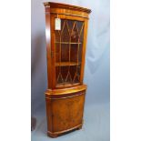 A mid 20th century yew wood corner cabinet