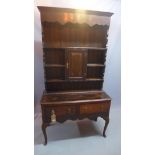 A late 19th/early 20th century oak dresser, with superstructure over two drawers, raised on cabriole