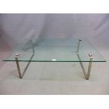 A Contemporary glass coffee table, raised on brushed steel legs, H.34 W.115 D.77cm