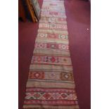 A mid 20th century Turkish Kilim runner, with geometric design, 335 x 77cm