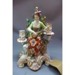 An early 20th century Meissen style porcelain figural candlestick holder, in the form of a lady