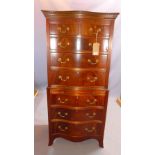 An early 20th century mahogany serpentine chest on chest, with two short over six long drawers,