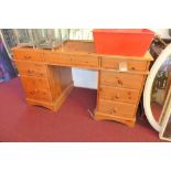 A 20th century pine pedestal desk, with eight drawers, H.77 W.136 D.64 cm