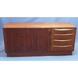 A mid 20th century Danish teak sideboard, with four drawers, beside tambour sliding door,