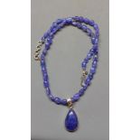A tanzanite beaded necklace with cabochon tanzanite drop pendant in white metal mount stamped 925,