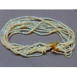 A silver gilt and opal beaded necklace, having nine strands of beaded opals, opals approx. 340cts,