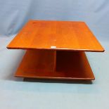 A mid 20th century G-plan teak coffee table, raised on castors, H.40 W.79 D.79cm