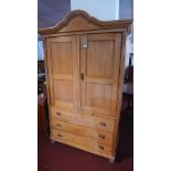 An early 20th century pine linen press, with two doors over three long drawers, reeded supports,