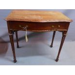 An early 20th century mahogany serpentine fronted side table, with single drawer, raised on carved