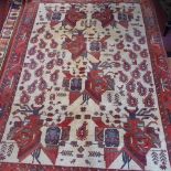 A Persian Qashqai rug, having geometric motifs on a cream ground, contained by geometric border on a