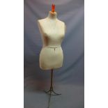 An early 20th century French mannequin, raised on wrought iron base