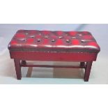 A adjustable duet piano stool, with red leather button down upholstery