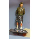 A 1940's hand painted lead car mascot, in the form of a Scottish soldier, H.18cm