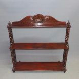 An early 20th century mahogany wall hanging waterfall bookcase, with bobbin supports, H.80 W.75 D.