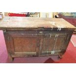 An early 20th century distressed pine low cabinet, with two doors, raised on block legs, H.76 W.