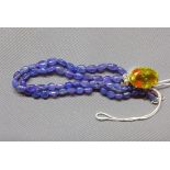 A tanzanite necklace with lemon quartz and white metal pendant stamped 925, having tanzanite beads