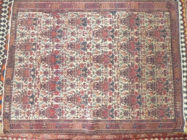 An extremely fine Northwest Persian Afshar rug with all over petal motifs on an ivory field within