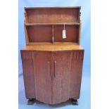 An Art Deco oak Ercol cabinet, with superstructure over two doors, enclosing drawer and shelf space,