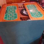 A 20th century Italian games table, comprising cards, chess and roulette, raised on cabriole legs