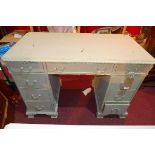 A 20th century grey painted pedestal desk, with seven drawers, raised on cabriole legs, H.77 W.110