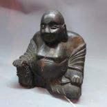 A carved and ebonised study of Buddha, H.17cm